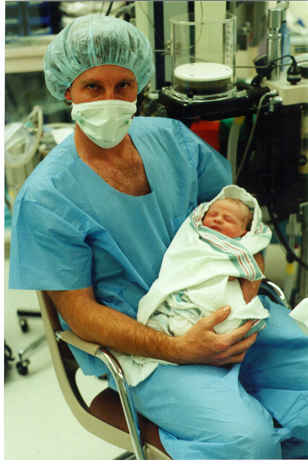 Dave holding Allison in operating room 