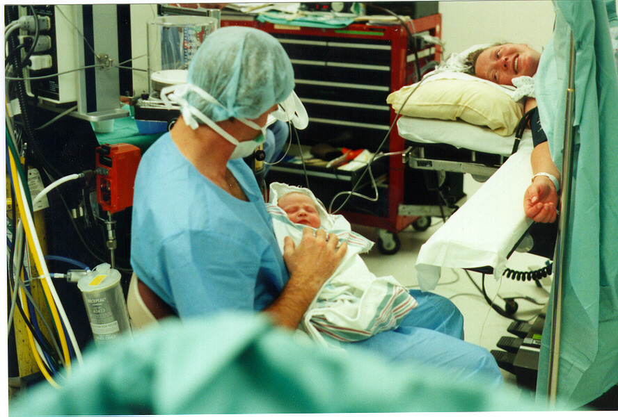 Dave holding Allison in operating room  